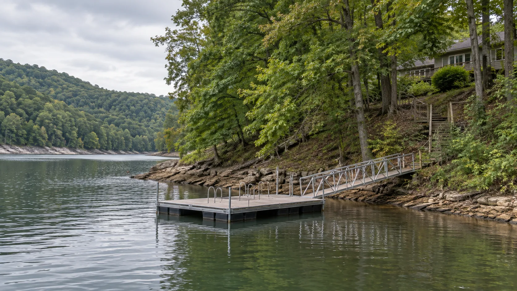 Illustrative view of a floating dock connected to a wooded Appalachian reservoir shore below a house